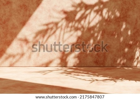 Concrete wall background with plant shadow. Summer tropical architecture scene. Product placement display on rustic cement texture stage.