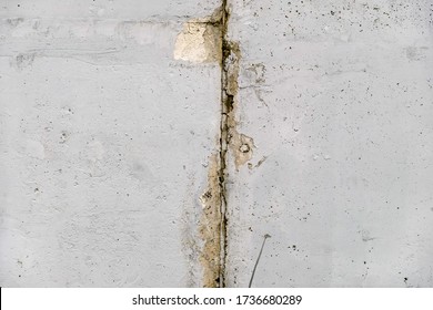 A Concrete Wall, Expansion Joint, Rust Stains On The Chipped Texture