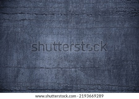 Concrete wall structure with  stripes pattern. Abstract architecture. Modern architectural detail. Traces of furrows or fissures. Geometric background with uneven parallel lines.