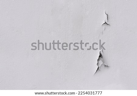 Concrete wall texture with Crack white color paint,Cement floor with Broken rough concrete surface,Light Grey background with plaster on building wall,Exterior wall Backdrop background with copy space