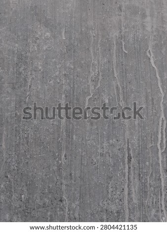Concrete Wall Texture With Dripping Cement 

Close-up of weathered gray concrete wall surface featuring vertical drips of cement liquid, fine grit particles, and rough urban grunge texture.