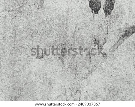 Concrete walls with black stains scattered all around, both dark and light.