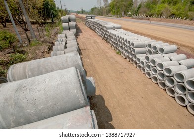 Concrete water drainage pipes stacked on ground