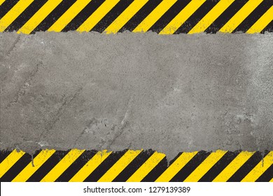 Concrete weathered wall background with yellow and black painted grunge hazard sign stripes and copy space