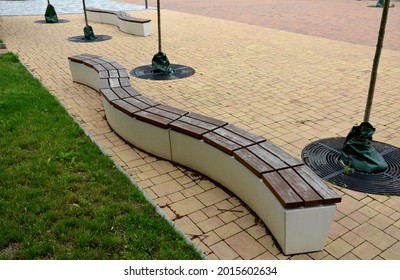 Concrete White Bench Block And Wave Shape In The Park On A Dark Cobbled Square, Clean Concrete Surface Gray Brown White Pedestrian And Rest Area At The Skate Park For Young People, Teenagers