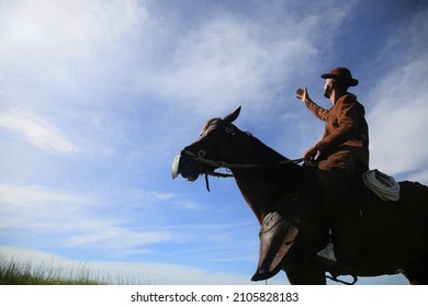 conde, bahia, brasil - january 8, 2022: Cowboy wearing traditional leather clothes with his horse on a farm in the city of Conde. - Shutterstock ID 2105828183
