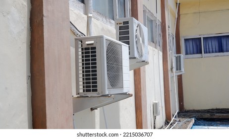 Condenser Or Compressor Unit Outside The House Or Residential Building. Central Air Conditioning Units (AC) Or Heating Ventilation Air Conditioning (HVAC) Systems. Electric Fan And Cooling Pump Inside