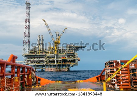 Condition of an open deck to stern of an anchor handling tug boat with oil production platform on the background, while on the job at offshore Terengganu oil field, Malaysia