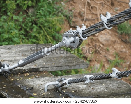 Condition U-bolts bonded to wire rope for strong rope to be used for fasten steel wire used to stretch bridge. Fastening stainless steel wire ropes with locking U-bolts. Steel clamp threaded both ends