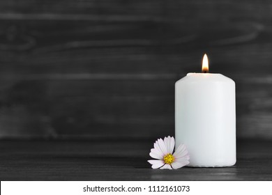 Condolence card with white burning candle and flower       