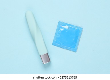 Condom with clitoral vibrator on a blue background. Sex games