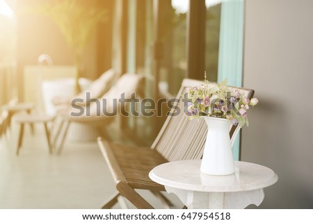 Condominium of balcony with small table chair and rose flowers. Soft light, Vintage image