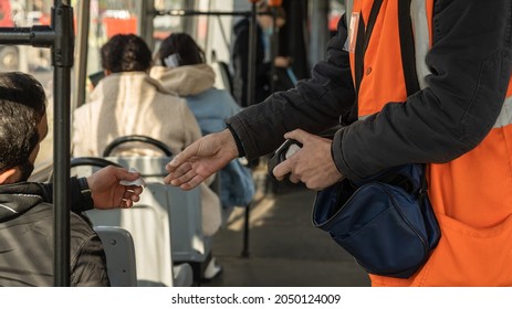 the conductor checks the passenger's ticket in transport. the person shows the ticket to the controller. advertising picture. a tram ride.
