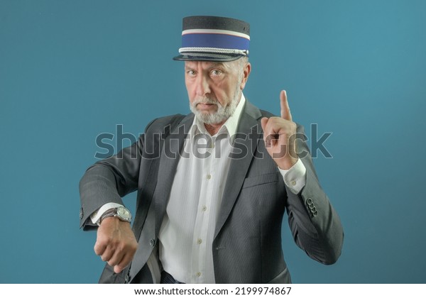 The conductor warns the\
passenger about the time of departure of the train. On a blue\
background.