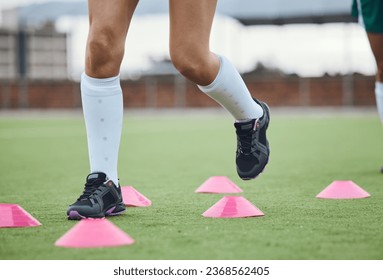 Cone, legs or athlete running in training, workout and warm up exercise on a outdoor hockey field or turf. Closeup, healthy or sports person on grass playing in a practice game for fitness speed - Powered by Shutterstock