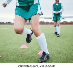 Cone, legs or team running for speed training, workout and warm up exercise on a outdoor hockey turf. Footwear closeup, balance or sports people on grass pitch playing in a practice game for fitness - Powered by Shutterstock