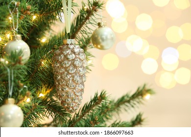 Cone Shaped Holiday Bauble Hanging On Christmas Tree Against Blurred Lights, Closeup. Space For Text