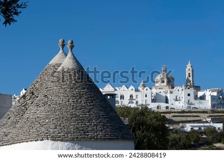 Cone shaped roofs of trulli outside the historic center of locorotondo, valle d'itria, bari district, puglia, italy, europe