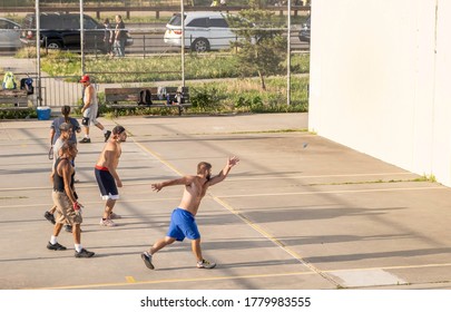 Coney Island, Brooklyn, New York - July 18, 2020: Guys Playing Wall Paddleball In A Coney Island Boardwalk Area