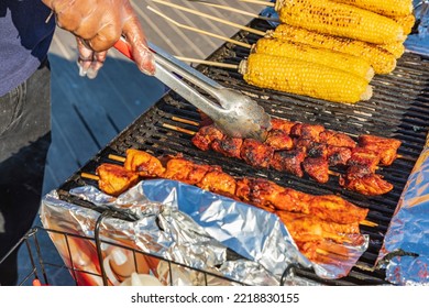 Coney Island, Brooklyn, New York, USA. Meat Kebabs And Corn On The Cob At A Sidewalk Food Stand.