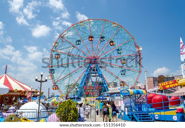 CONEY ISLAND - MAY 30: The famous Wonder Wheel in Coney\
Island, May 30, 2013. The Eccentric Ferris Wheel was built in 1920,\
it has 24 fully enclosed cars,giving a total capacity of 144\
passengers  