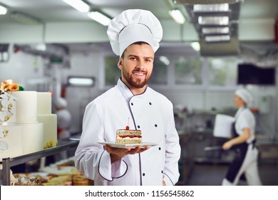 A Confectioner With Dessert In His Hands.