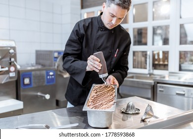 Confectioner Pouring Chocolate On The Ice Cream, Making Ice Cream On The Kitchen Of A Small Manufacturing Or Restaurant