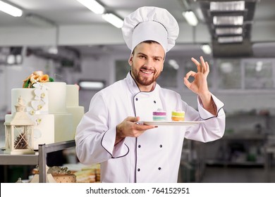 The confectioner is preparing a cake in the kitchen of the pastr