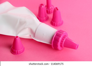 confectionery bag and replaceable nozzles, on pink background - Shutterstock ID 114069175