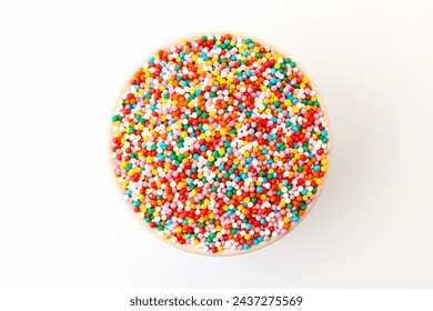Confectionery sprinkles in bowl on white background. Decoration for cake and bakery. Top view - Powered by Shutterstock