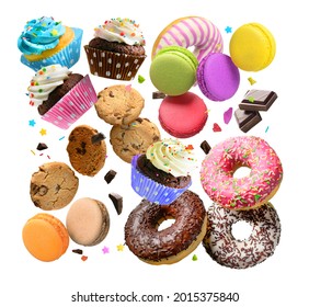 Confectionery and sweets collage. Donuts, cupcakes, cookies, macarons flying over white background.
