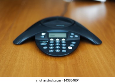 Conference Business Phone In Meeting Room On A Wooden Background