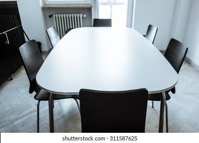 A Conference Or Dining Modern Sleek Table In A Small Room