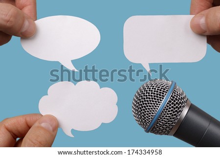 Conference, interview or social media concept with microphone and blank speech bubbles