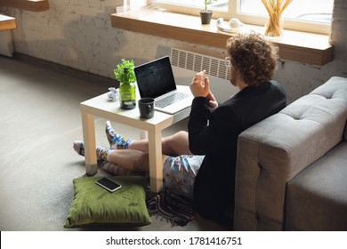 Conference, Meeting. Man Without Pants But In Jacket Working On A Computer, Laptop. Remote Office During Coronavirus, Fun And Comfortable In Underpants. Insulation, Quarantine, Humor, Business Concept