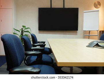 Conference Meeting Room With Ceiling LED Lights, Used Luxury Ergonomics Chairs, Table And TV Set Interior Furniture. Business Meeting, Conference, Training Course, Lecture In The Elegant Design Office