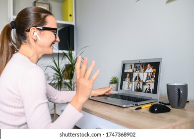 Conference, Morning Meeting Online. A Young Woman Is Using Laptop For Connection With Colleagues, Employees. Video Call With Many People Together. Back View