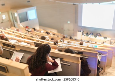 Conference and Presentation. Audience at the conference hall. Business and Entrepreneurship. Faculty lecture and workshop. Audience at the lecture hall. Academic education. Student making notes. - Shutterstock ID 259108340