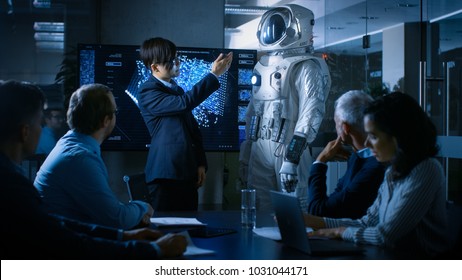 In the Conference Room of the Center of Technology Chief Engineer Presents Next Generation Space Suit to a Board of Directors. Completely Original Design with Integrated AI and Neural Network Systems. - Powered by Shutterstock