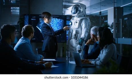 In the Conference Room Chief Engineer Presents Next Generation Space Suit to a Board of Directors. Completely Original Design with Integrated AI and Neural Network Systems. New Level of Space Travel. - Powered by Shutterstock