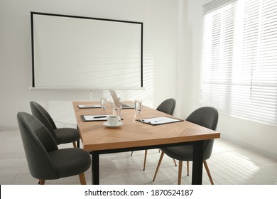 Conference Room Interior With Wooden Table And Video Projection Screen