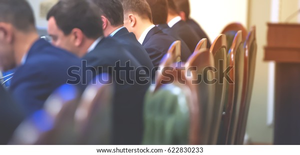 Conference room or seminar meeting room in\
business event. Session of Government. Academic classroom training\
course in lecture hall. blur abstract background. working in modern\
bright office indoor