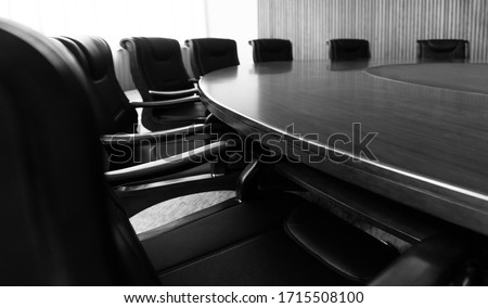 Conference table and chairs in modern meeting room.