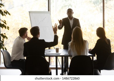 Conference Training Male Participant Raise Hand Ask African Speaker Presenter Question At Diverse Group Corporate Meeting Showing Initiative At Team Workshop, Knowledge And Business Education Concept