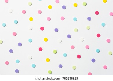 Confetti. Colorful dots view from above on a light background. Top view