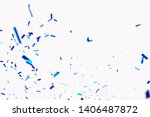 Confetti from crackers. Blue elements on a white background. Shot of confetti at a party. Festive mood. Serpentine, festive decor