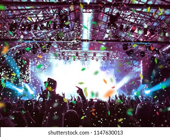 Confetti Falling On A Festive Concert Crowd In Front Of The Main Stage