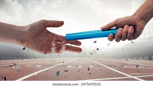 Confetti falling over close up of a hand passing a baton against sports field. sports and tournament concept - Powered by Shutterstock