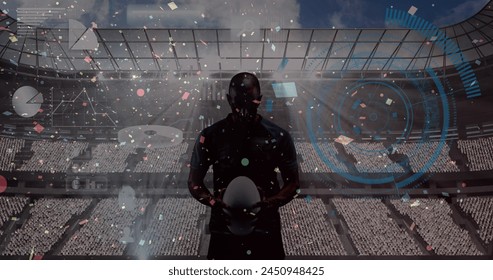 Confetti falling and round scanner against male rugby player holding a ball against sports stadium. sports competition and tournament concept - Powered by Shutterstock
