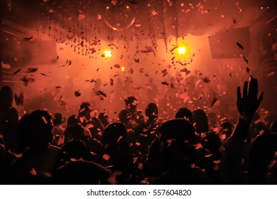 Confetti Fired On Air During A Party In A Disco. Confetti For Background. Silhouette Of Happy People On Dancefloor